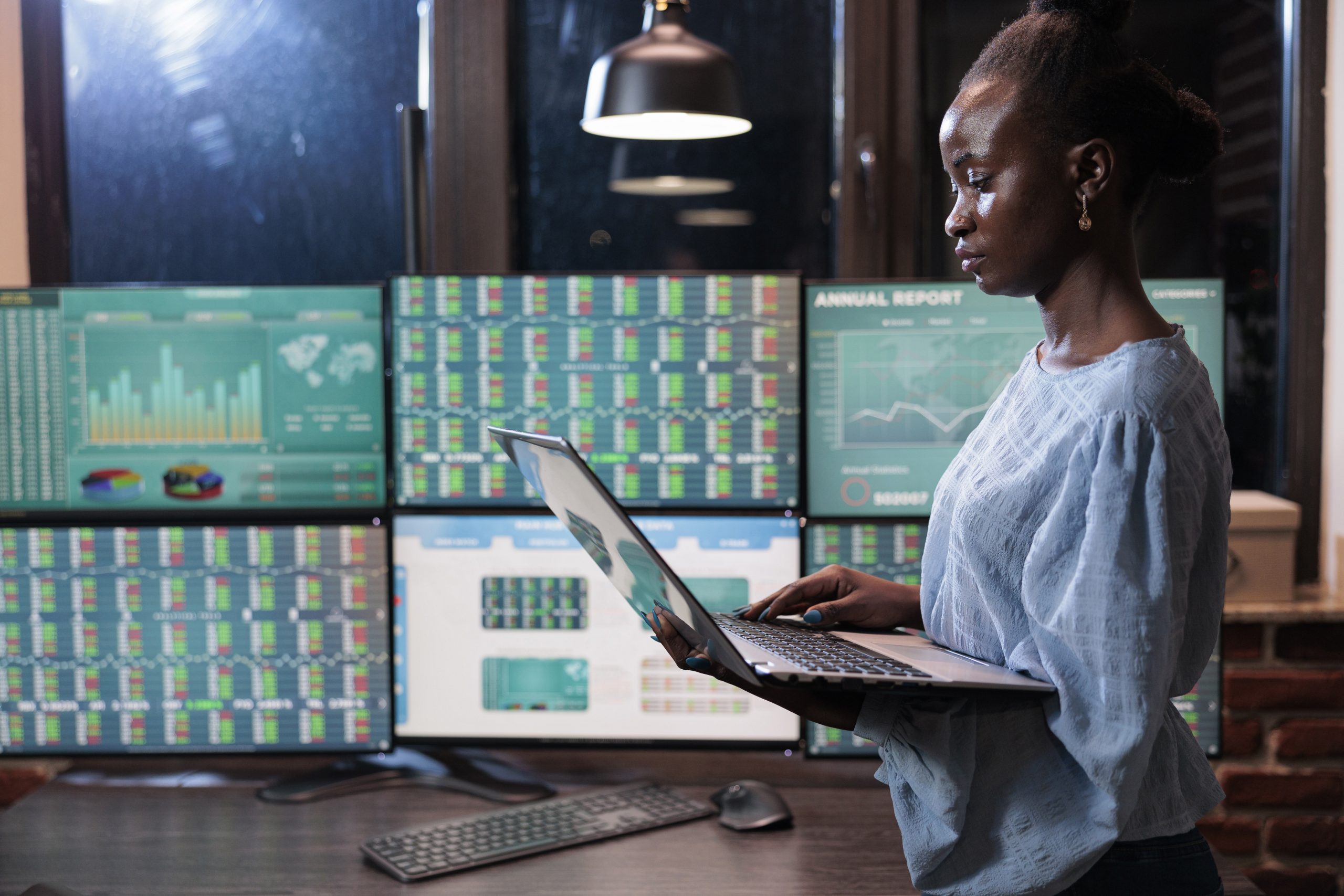 Forex stock market company professional trading agent using laptop to analyze live financial graphs.